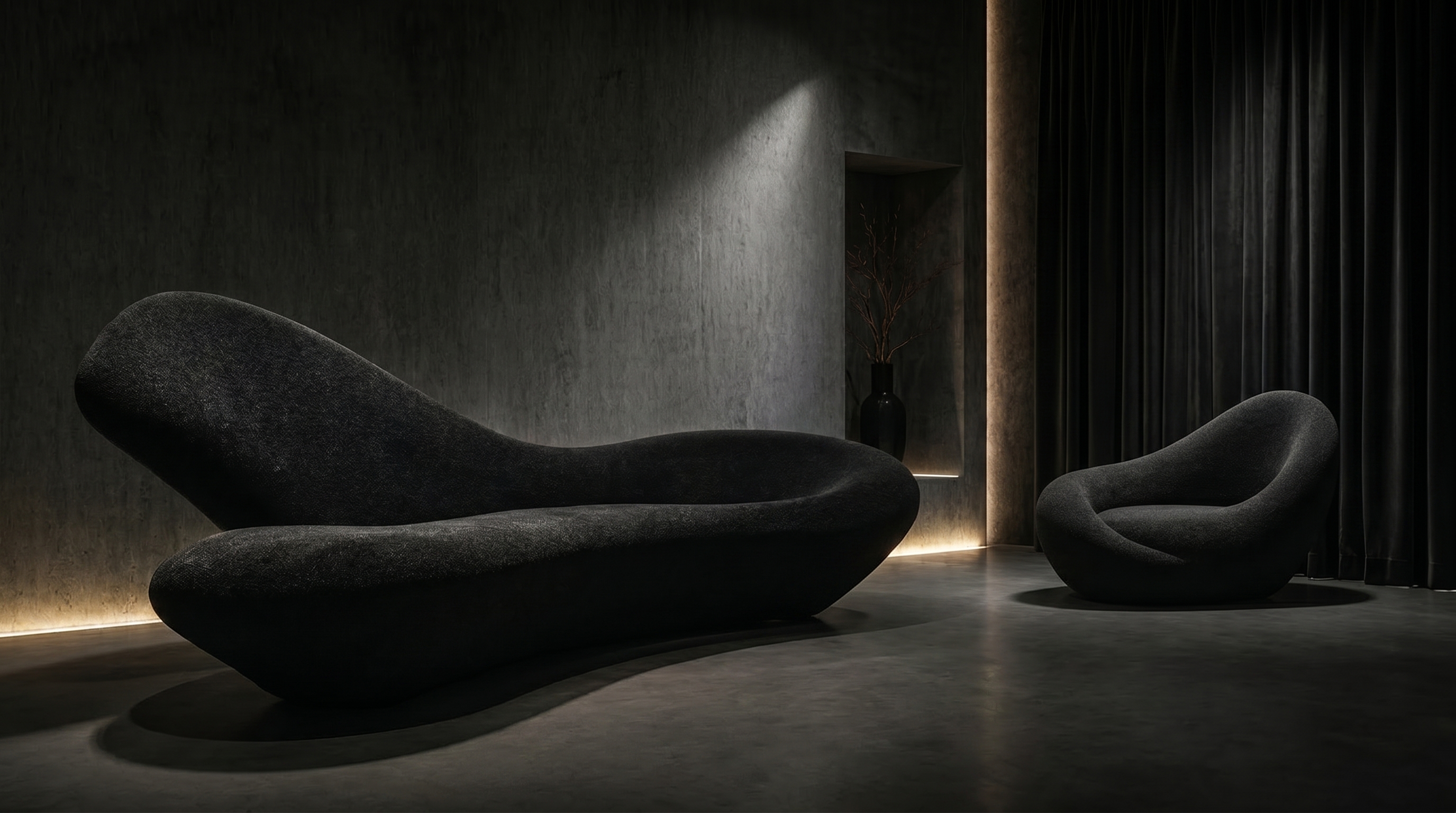 UMBRA sofa and armchair together in a dark architectural room.